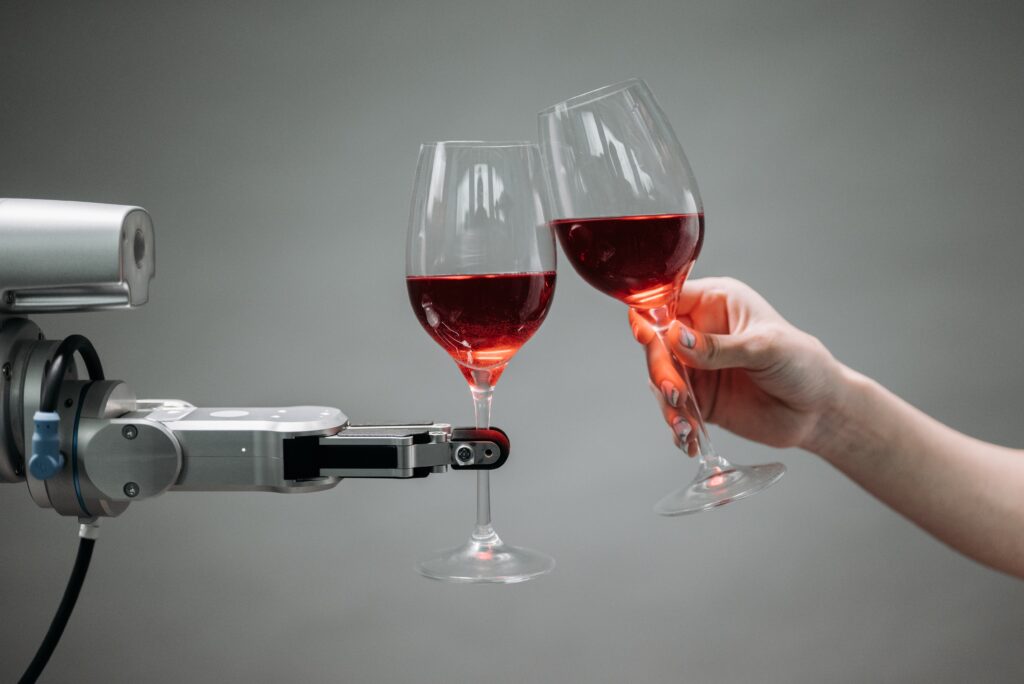 maszyna stuka się kieliszkiem wina z człowiekiem